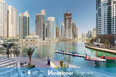 a river in the middle of a city with tall buildings at Vacationer l Lux 2 Bedroom Apartment with Marina & Skyline View Prime Location in Dubai