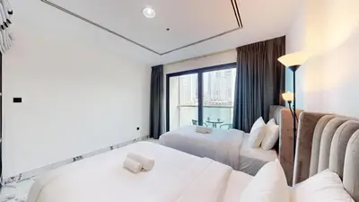 a hotel room with two beds and a window at Vacationer l Lux 2 Bedroom Apartment with Marina & Skyline View Prime Location in Dubai
