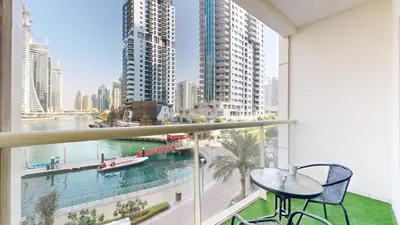 a balcony with a table and a view of a city at Vacationer l Lux 2 Bedroom Apartment with Marina & Skyline View Prime Location in Dubai