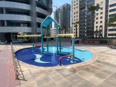 a small pool with a slide in a city at Vacationer l Lux 2 Bedroom Apartment with Marina & Skyline View Prime Location in Dubai