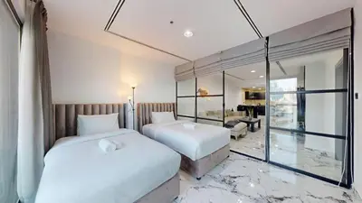 a bedroom with two beds and a living room at Vacationer l Lux 2 Bedroom Apartment with Marina & Skyline View Prime Location in Dubai