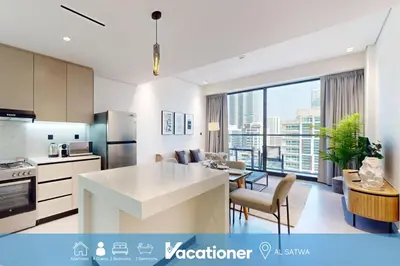 a kitchen and living room with a large window at Vacationer I Premium 2 Bedroom Apartment I Close to DIFC & WTC I Central Location in Dubai