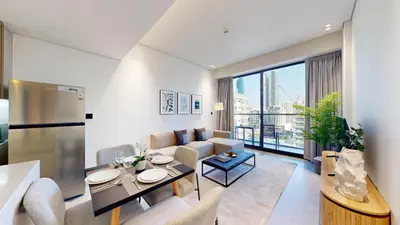 a living room with a couch and a table at Vacationer I Premium 2 Bedroom Apartment I Close to DIFC & WTC I Central Location in Dubai