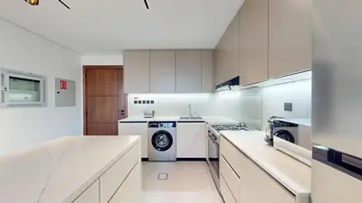 a kitchen with white cabinets and a washer and dryer at Vacationer I Premium 2 Bedroom Apartment I Close to DIFC & WTC I Central Location in Dubai