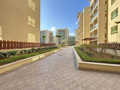 a walkway in the middle of a city with buildings at Vacationer l Upgraded Chic 2 Bed l Pool View l Free Pool, Gym Access in Dubai