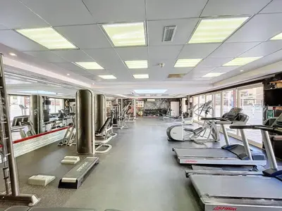 a gym with lots of treadmills and machines at Vacationer l Upgraded Chic 2 Bed l Pool View l Free Pool, Gym Access in Dubai