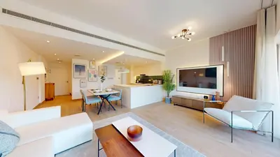 a living room with a couch and a tv at Vacationer l Upgraded Chic 2 Bed l Pool View l Free Pool, Gym Access in Dubai