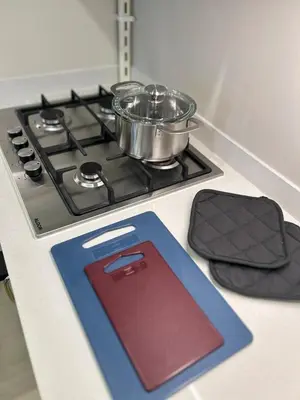 a stove with pots and pans on top of it at Modern Apartment in JVC in Dubai