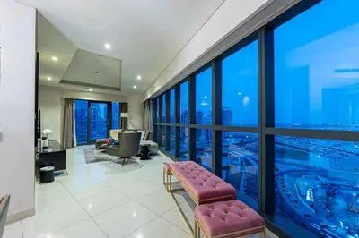 a living room with a view of a city at Venetian - High Floor 2BR Residence with Incredible Burj View in Dubai