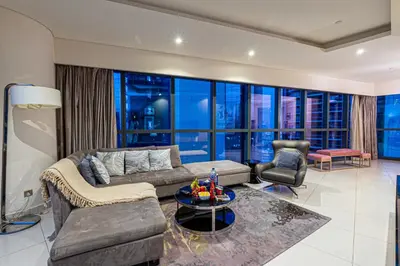 a living room with a couch and a table at Venetian - High Floor 2BR Residence with Incredible Burj View in Dubai