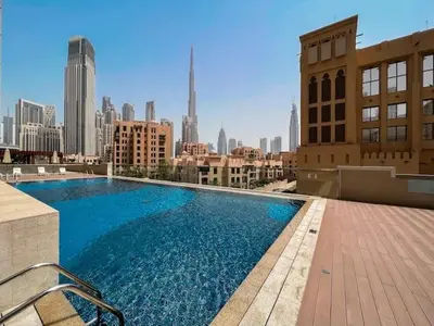 a large blue swimming pool on top of a building at Vogue Downtown Bellevue Towers near Burj Khalifa and Dubai Mall, One Bedroom Apartment with City View, Full Access to all Amenities in Dubai