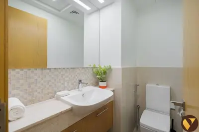 a bathroom with a sink and a toilet at Vogue Downtown Bellevue Towers near Burj Khalifa and Dubai Mall, One Bedroom Apartment with City View, Full Access to all Amenities in Dubai