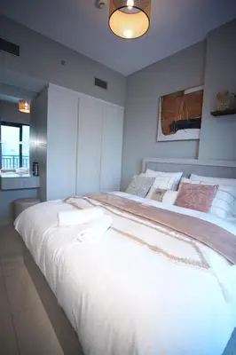 a bedroom with two large beds with white sheets at Joyful Journeys Downtown And Burj View Residence Business Bay One-Bedroom Apartment in Dubai