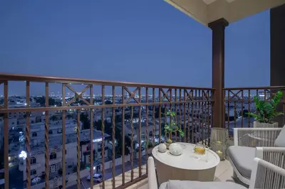 a balcony with a table and a view of a city at Frank Porter - Rahaal 2 in Dubai