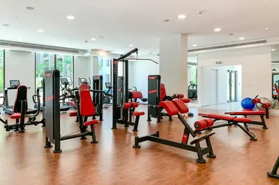 a gym with a lot of treadmills and machines at Frank Porter - Rahaal 2 in Dubai