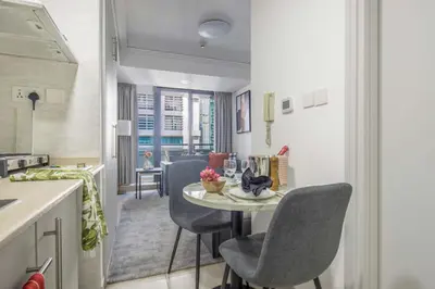 a kitchen and dining room with a table and chairs at Frank Porter - Goldcrest Views 2 in Dubai