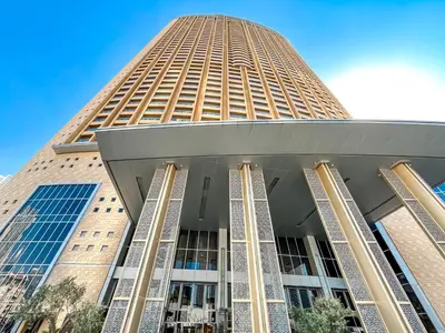 a large building with a tall tower at 1BR Apt Kempinski Central Avenue Downtown Dubai in Dubai