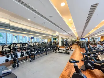 a gym with rows of treadmills and machines at 1BR Apt Kempinski Central Avenue Downtown Dubai in Dubai