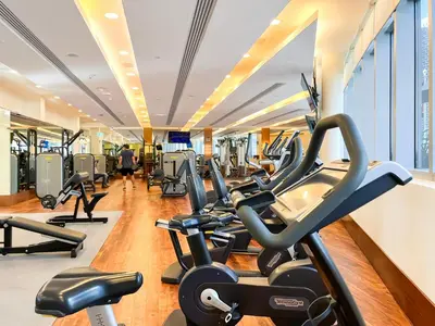 a gym with cardio machines and treadmills at 1BR Apt Kempinski Central Avenue Downtown Dubai in Dubai