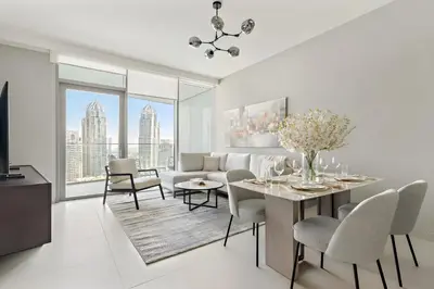 a living room with a table and chairs and a couch at Luxury 1BR in LIV Marina with Canal Views in Dubai