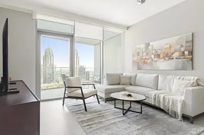 a living room with a white couch and a table at Luxury 1BR in LIV Marina with Canal Views in Dubai