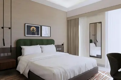 a bedroom with a large white bed and a mirror at Marriott Executive Apartments Jumeirah Lakes Towers, Dubai in Dubai
