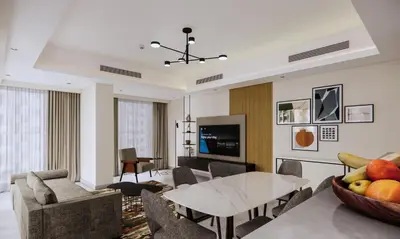 a living room with a table and a couch at Marriott Executive Apartments Jumeirah Lakes Towers, Dubai in Dubai