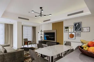 a living room with a table and a couch at Marriott Executive Apartments Jumeirah Lakes Towers, Dubai in Dubai