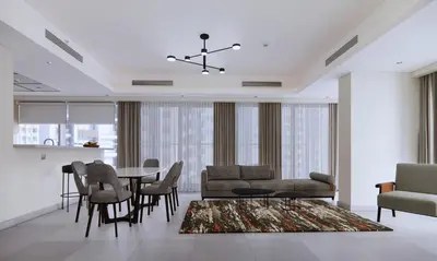 a living room with a dining room table and chairs at Marriott Executive Apartments Jumeirah Lakes Towers, Dubai in Dubai