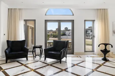 a living room with two chairs and a window at Luxury 5BR plus Maid Private Villa with Direct Beach Access in Dubai