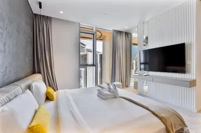 a bedroom with a large bed and a flat screen tv at Mira Holiday Homes - Sky High Bliss at Bluewaters Residence 3 Ain View in Dubai