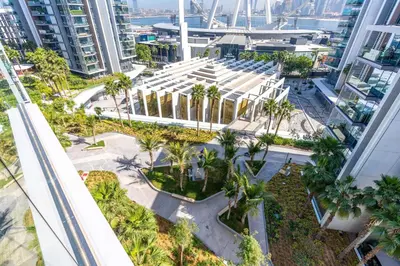 an overhead view of a building with palm trees at Mira Holiday Homes - Sky High Bliss at Bluewaters Residence 3 Ain View in Dubai