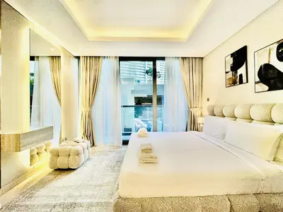 a bedroom with a large bed with a large window at Venduras - Luxe Studio, City Views , Sterling by Omniyat in Dubai