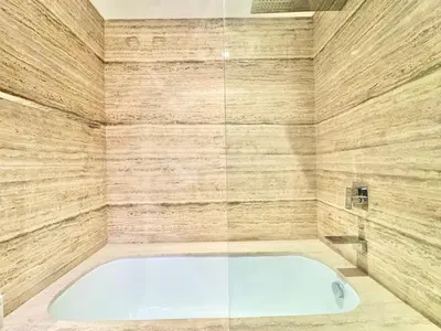 a bathroom with a tub and a glass shower at Venduras - Luxe Studio, City Views , Sterling by Omniyat in Dubai