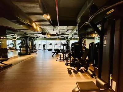 a gym with a row of treadmills and machines at Venduras - Luxe Studio, City Views , Sterling by Omniyat in Dubai