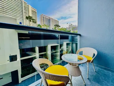 a balcony with a table and chairs on a building at Venduras - Luxe Studio, City Views , Sterling by Omniyat in Dubai