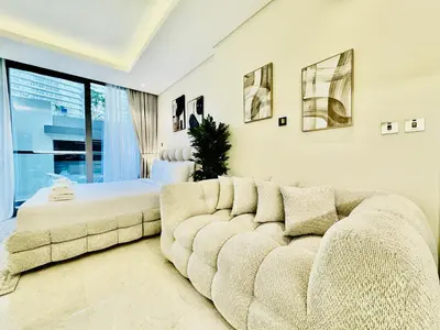 a living room with a couch and a bed at Venduras - Luxe Studio, City Views , Sterling by Omniyat in Dubai