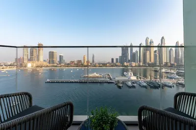 a view of a harbor from a balcony with benches at Palace Beach Residence 2, Emaar Beachfront - Mint Stay in Dubai