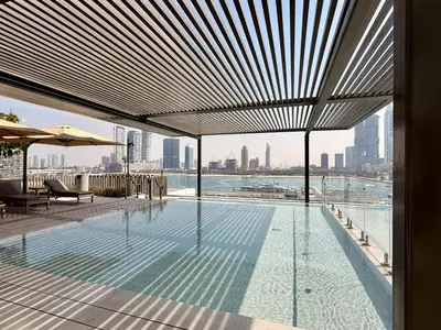 a swimming pool with a view of the city at Palace Beach Residence 2, Emaar Beachfront - Mint Stay in Dubai