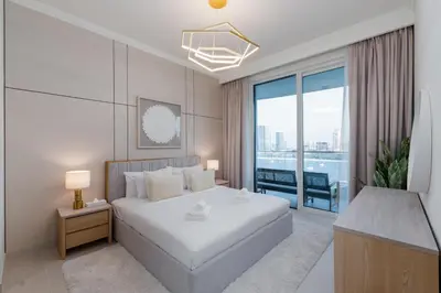 a bedroom with a white bed and a large window at Palace Beach Residence 2, Emaar Beachfront - Mint Stay in Dubai