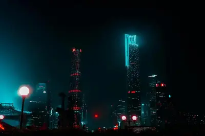 a city skyline with tall skyscrapers at night at A981 - kasturba Apt gandhi road in Dubai