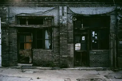 an old brick building with doors and windows at A981 - kasturba Apt gandhi road in Dubai
