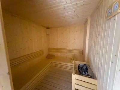 an empty sauna with wooden walls and wooden floors at Meydan Luxury Stylish 2BR with Pool & City Views in Dubai