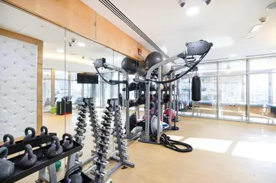 a gym with exercise equipment in a room at StayMada - Ocean Heights Panoramic Beach Views in Dubai