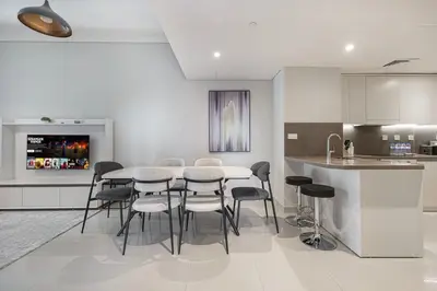 a kitchen with a table and chairs and a counter at StayMada - Ocean Heights Panoramic Beach Views in Dubai