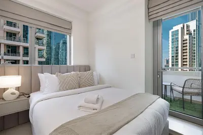 a bedroom with a large bed and a large window at The Burj View Suite by NAMUVE at BLVD Central in Dubai
