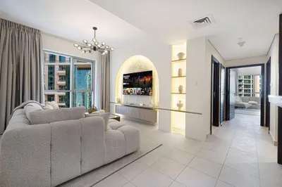 a living room with a couch and a large window at The Burj View Suite by NAMUVE at BLVD Central in Dubai