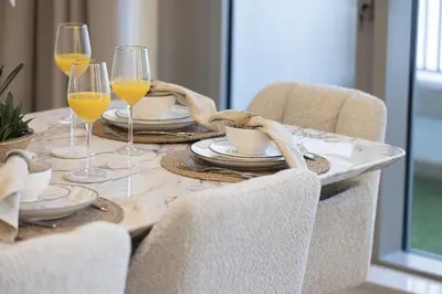 a dining room table with glasses of orange juice at The Burj View Suite by NAMUVE at BLVD Central in Dubai
