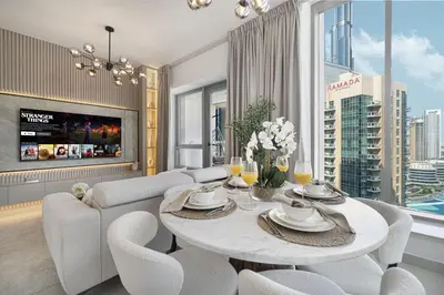 a living room with a table and chairs and a couch at The Imperial Burj View by NAMUVE at 29 Boulevard in Dubai