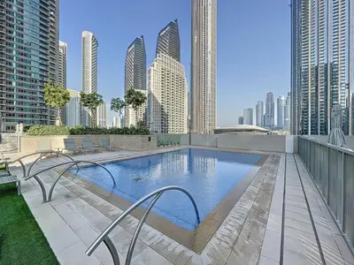 a swimming pool on the roof of a building with tall buildings at Locations I Downtown Dubai I Premium 3BR Apartment I Luxury & Modern Interiors I Stunning Burj Khalifa Views I Steps from Dubai Mall & Dubai Fountain in Dubai
